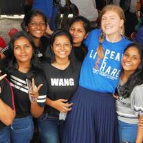Teacher socialising with students at an event