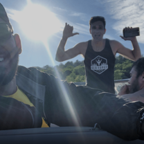 Young man takes selfie while on motor boat in Old Forge, New York