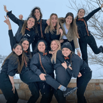 Group of young people posing in the snow