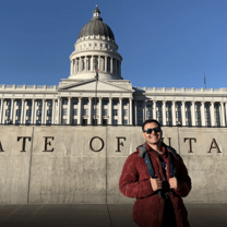 Young man in front of Utah state capitol
