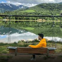 Contemplative young man beside lake