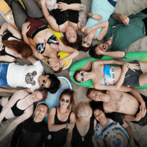 Group of surfers lying on beach