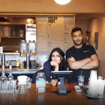Young man and young woman at coffee shop counter in Provincetown, Massachusetts