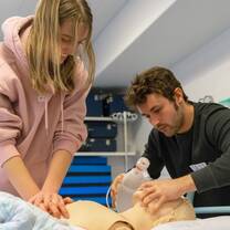 A female and male students are simulating CPR at a hospital