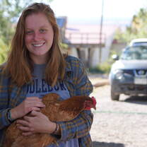 Student holding rooster