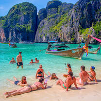 Backpacking Thailand group relaxing on the beach