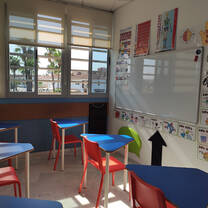 Classroom of the company is shown with whiteboard, tables and chairs