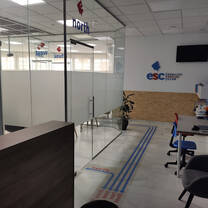 Hallway of company is shown with desk and chairs