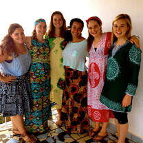 Students wearing traditional outfits posing for a photo