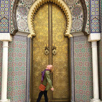 A student striking a pose in front of a temple door