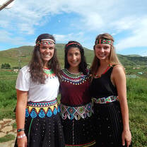 Student wearing traditional clothing posing together