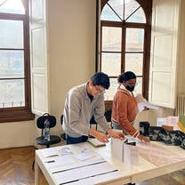 Two students working side by side on a design project at the San Lorenzo campus