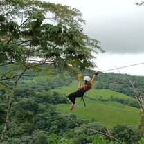 Girl ziplining in trees
