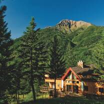 Wood building beside mountain. 