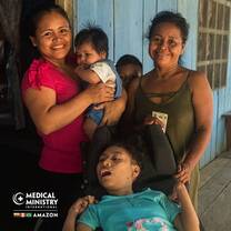 Family of women smile at camera