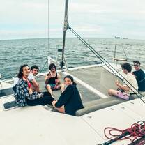 A group smiles while sitting on a boat 