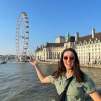 Intern smiling in front of the London Eye