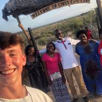 A tourist volunteer with fellow volunteers and women from the community