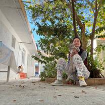 Erica is the general manager of the house, here with her cat named Douglas in the garden of the property.