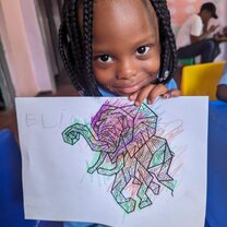 A girl holding her drawing