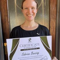 woman smiling with a certificate 