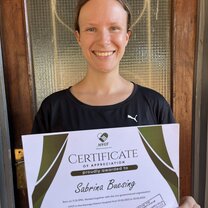 woman smiling with a certificate 