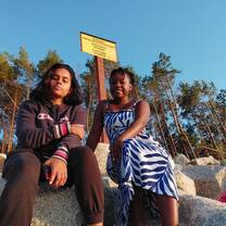 Two women sitting in the sun