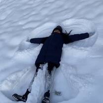 Woman making snow angel
