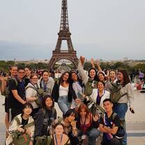 large group posing in front of the Eiffel Tower