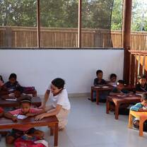 Volunteer working with students