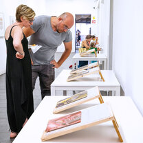 Professors looking at students' final work during the Student Show.