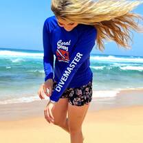 female divemaster walking on beach