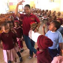 Teacher Lilian posing with students after a session 