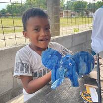 student showing his art project