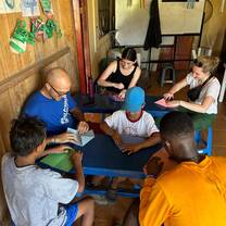 people sitting around table doing a craft