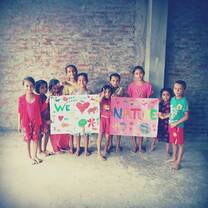 Alisha and her friend colour in daycare center