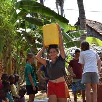 Girl with water canteen on her head