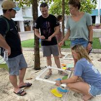a group stands around learning 