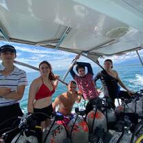 a group poses for a photo on a boat 