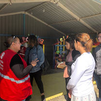 Students listening to a Save the Children worker speak 