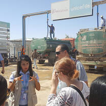 Students listening to a humanitarian worker speak.