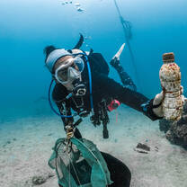A diver helps clean the ocean 