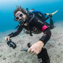 a diver helps clean up the ocean
