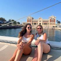 two girls smiling on a catamaran adventure