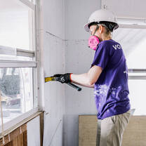 Disaster relief volunteer working inside a home impacted by Hurricane Ian