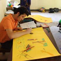 man drawing a poster
