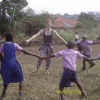 woman and children holding hands in a circle