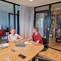 two students speaking at a table