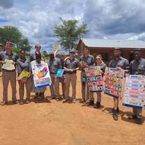 group smiling with people from a local community 