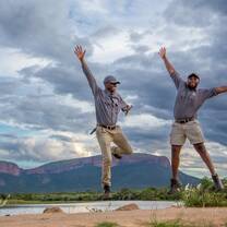freeze frame of two people jumping 